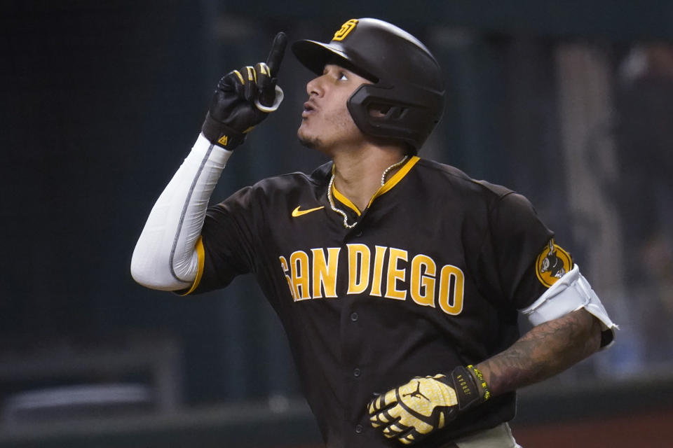 San Diego Padres' Manny Machado points upward while rounding the bases on his solo home run off Los Angeles Dodgers' Clayton Kershaw during the sixth inning in Game 2 of a baseball National League Division Series Wednesday, Oct. 7, 2020, in Arlington, Texas. (AP Photo/Sue Ogrocki)