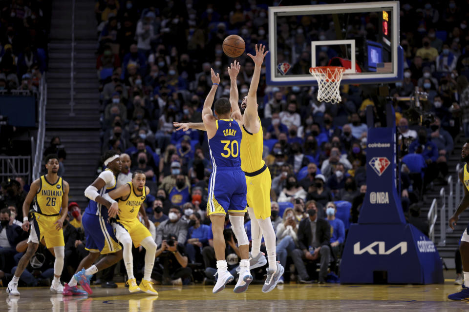 Golden State Warriors guard Stephen Curry (30) shoots against Indiana Pacers center Goga Bitadze during the first half of an NBA basketball game in San Francisco, Thursday, Jan. 20, 2022. (AP Photo/Jed Jacobsohn)