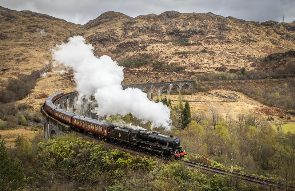 <p>The first Jacobite Express of the 2021 season crosses the Glenfinnan Viaduct on its way to Mallaig from Fort William as travel across Scotland is now permitted following the easing of coronavirus restrictions. Picture date: Monday April 26, 2021.</p>
