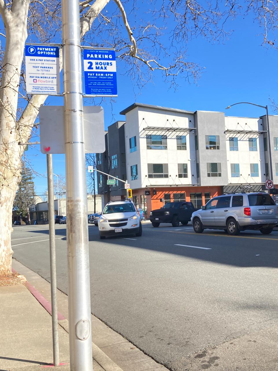 Signs are up in downtown Redding announcing the hours that paid parking will be enforced. This is near the corner of Placer and Pine streets on Monday, Feb. 13, 2023.