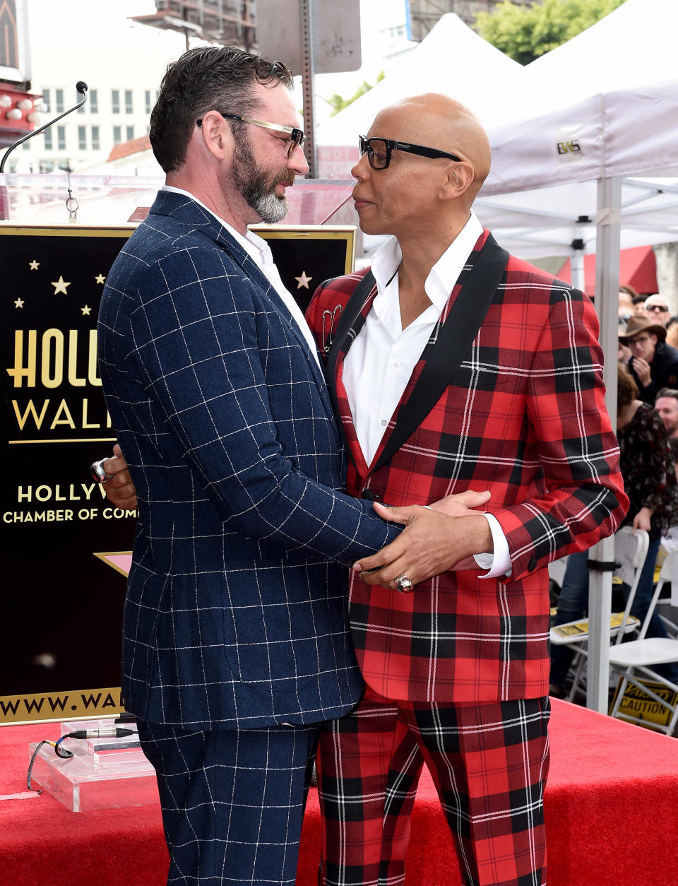 Georges and RuPaul hugging on a red carpet