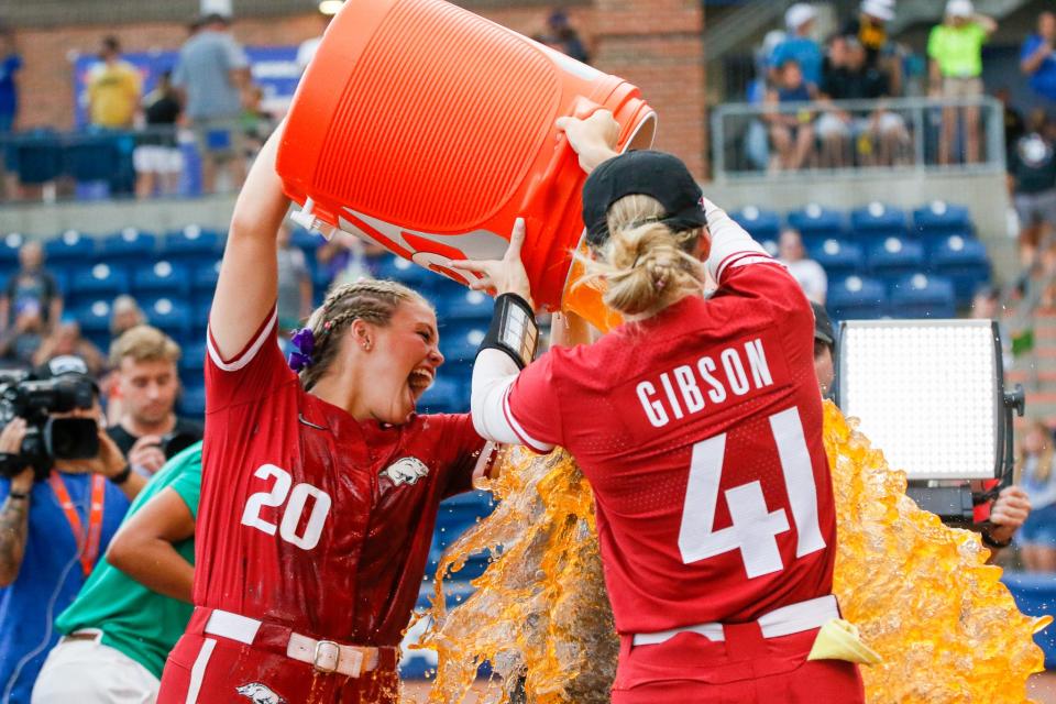 Arkansas Razorbacks utility Hannah Gammill (20) and infielder Danielle Gibson (41) pour Gatorade on Head Coach Courtney Deifel after the Razorbacks win over the Missouri Tigers and winning the SEC Softball Tournament at Katie Seashole Pressly Stadium at the University of Florida in Gainesville, FL on Saturday, May 14, 2022. [Gabriella Whisler/Special to the Sun]