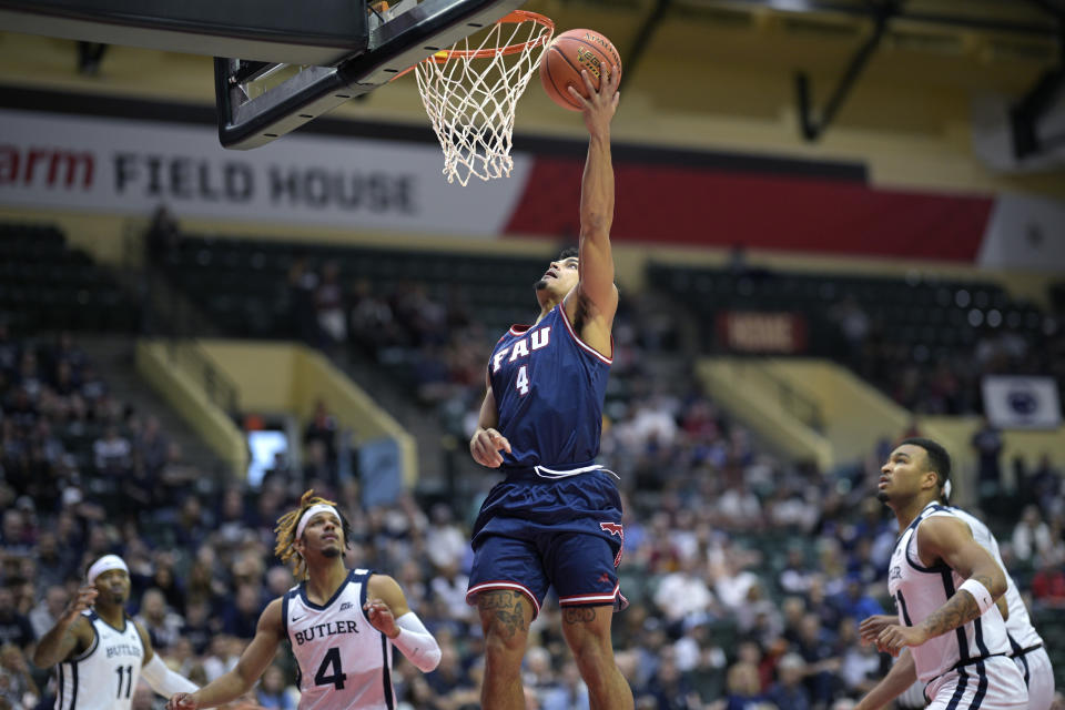 Florida Atlantic guard Bryan Greenlee (4) goes up for a shot in front of Butler guard DJ Davis (4) during the first half of an NCAA college basketball game, Thursday, Nov. 23, 2023, in Kissimmee, Fla. (AP Photo/Phelan M. Ebenhack)