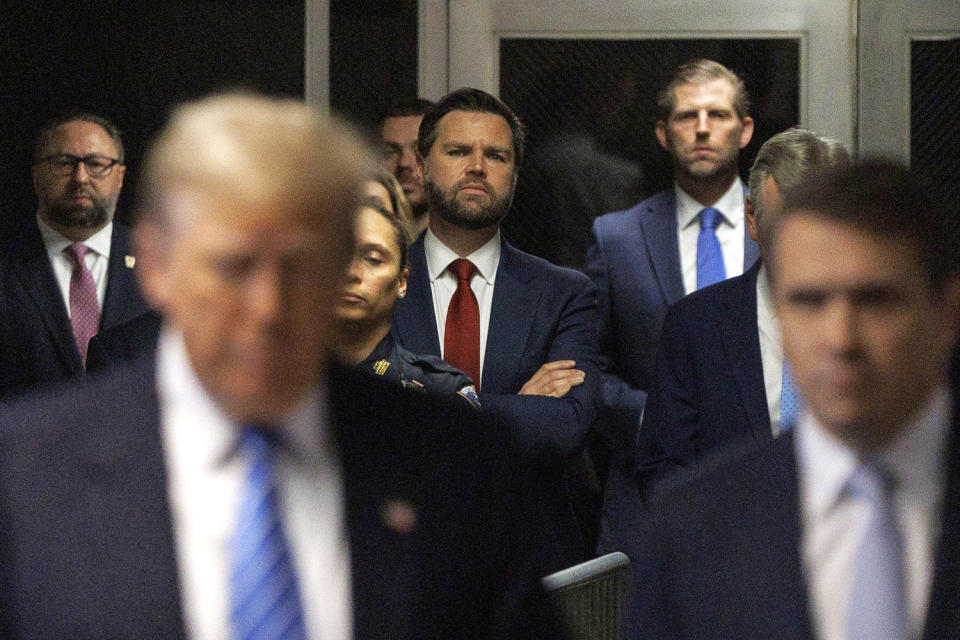 J.D. Vance looks on as Donald Trump speaks to the media. (Sarah Yenesel / Pool via Getty Images)