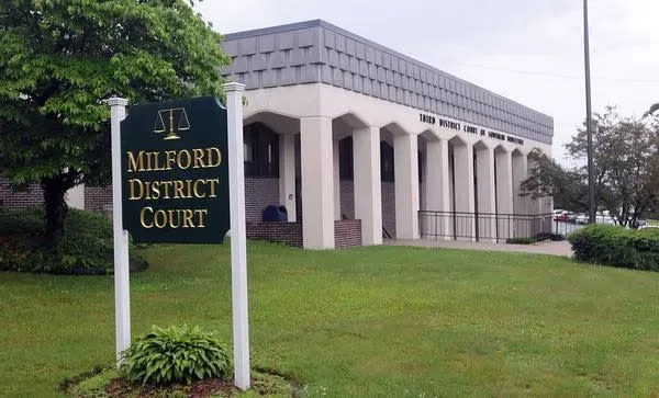 Two men suspected of brandishing a gun and robbing a Milford meat market were scheduled to be arraigned Tuesday in Milford District Court.