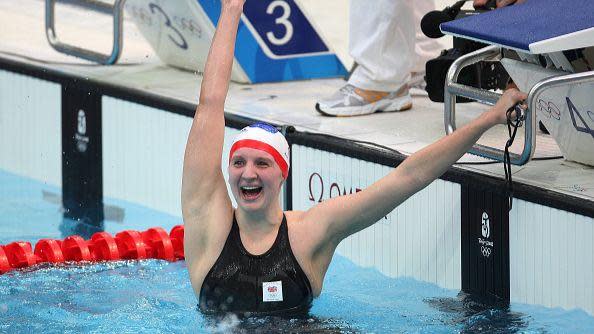 Rebecca Adlington holds her arm aloft to celebrate in the pool after winning gold in the Women's 800m Freestyle Final during Beijing Olympic Games.