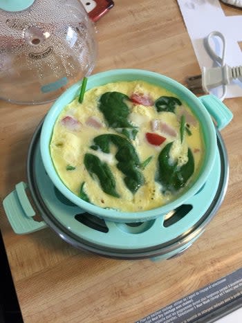 reviewer cooking an omelet in the blue rapid cooker