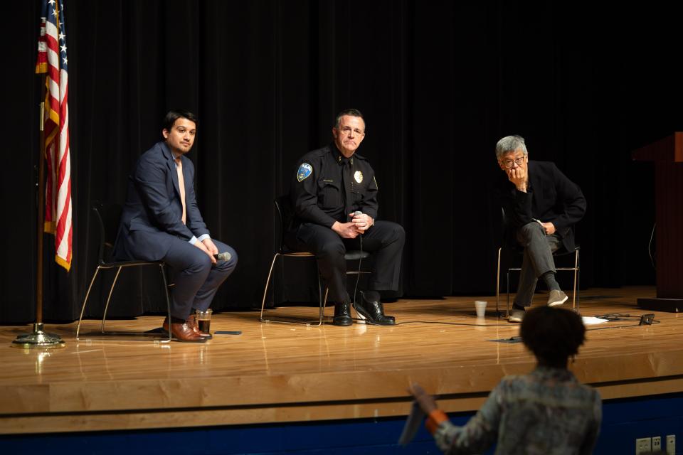 From left, Akron Mayor Shammas Malik, Deputy Police Chief Brian Harding, and moderator Brant Lee listen to community members' questions Saturday at Buchtel CLC.