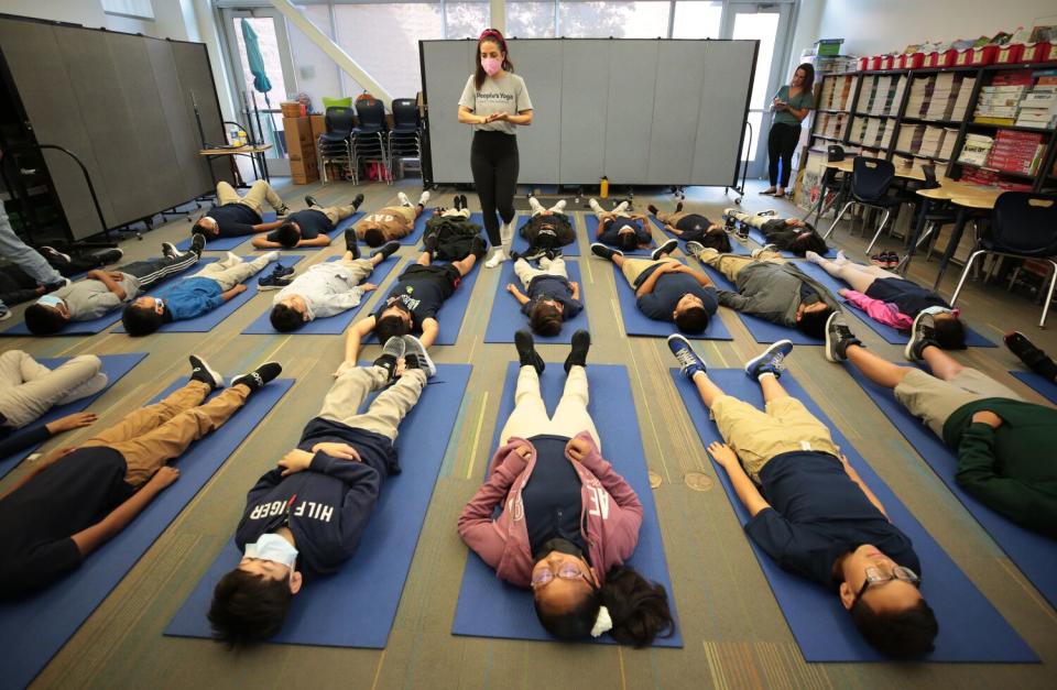 Leah Gallegos, a co-founder of People's Yoga is leading the 5th grade class at Accelerated Charter Elementary School