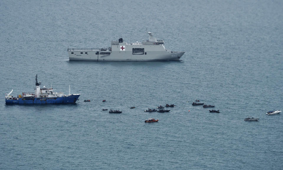 Rescue boats are seen on the Java Sea as the search for the wreckage of the Sriwijaya Air flight that crashed on Saturday continues in this aerial shot taken from an Indonesian Navy aircraft, near Jakarta, Indonesia, Thursday, Jan. 14, 2021. An aerial search for victims and wreckage of a crashed Indonesian plane expanded Thursday as divers continued combing the debris-littered seabed looking for the cockpit voice recorder from the lost Sriwijaya Air jet. (AP Photo/Eric Ireng)