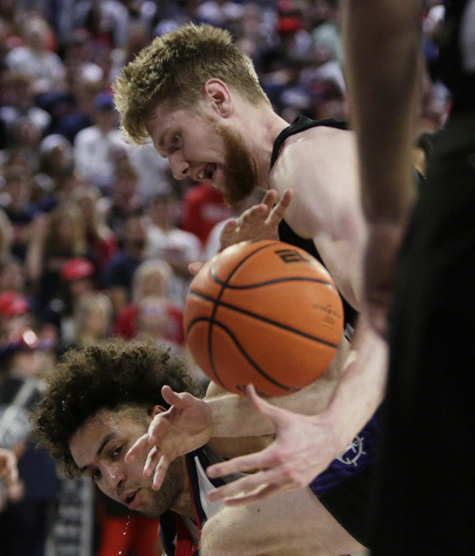 Gonzaga forward Anton Watson, left, and Portland forward Kristian Sjolund go after the ball during the first half of an NCAA college basketball game Saturday, Jan. 14, 2023, in Spokane, Wash. (AP Photo/Young Kwak)