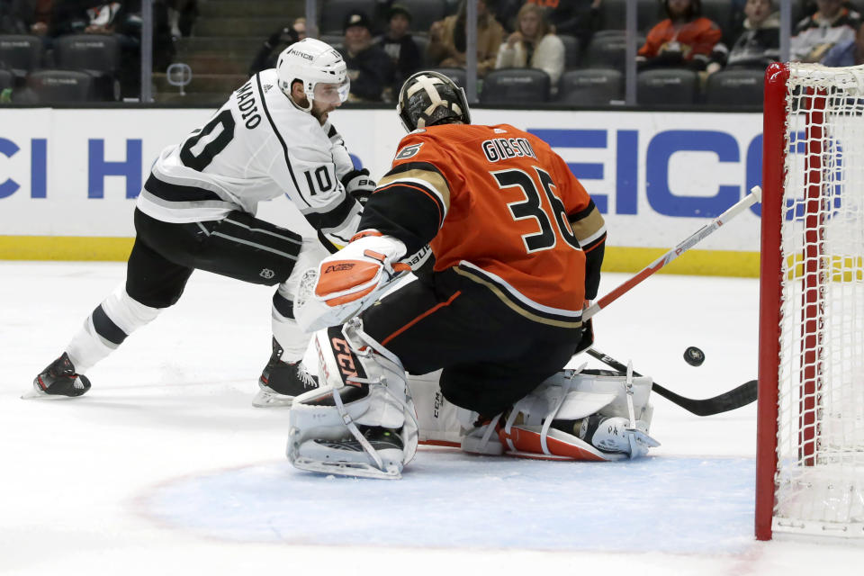 Los Angeles Kings center Michael Amadio, left, shot is blocked by Anaheim Ducks goaltender John Gibson, right, during the first period of an NHL hockey game in Anaheim, Calif., Thursday, Dec. 12, 2019. (AP Photo/Alex Gallardo)