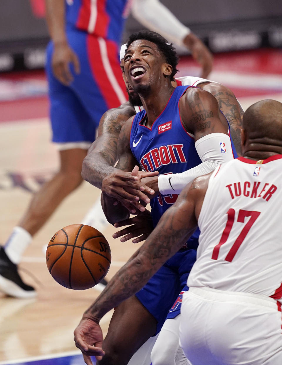 Houston Rockets center DeMarcus Cousins knocks the ball away from Detroit Pistons guard Delon Wright during the first half of an NBA basketball game, Friday, Jan. 22, 2021, in Detroit. (AP Photo/Carlos Osorio)