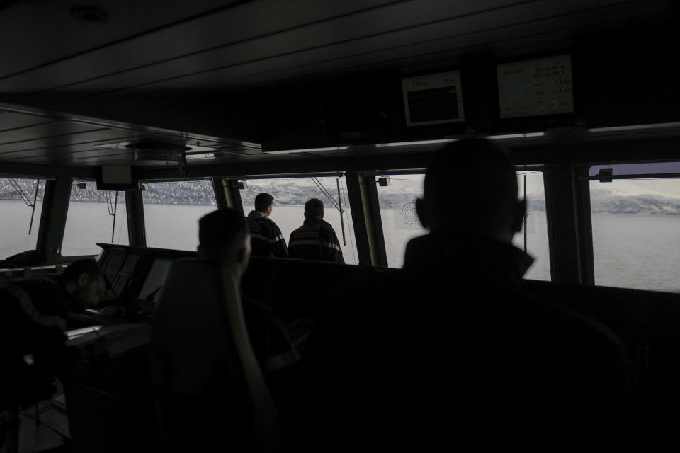 French sailors on the bridge of the French navy frigate Normandie keep watch as the vessel patrols in a Norwegian fjord, north of the Arctic circle, for a reconnaissance patrol, Wednesday March 6, 2024. The French frigate is part of a NATO force conducting exercises in the seas, north of Norway, codenamed Steadfast Defender, which are the largest conducted by the 31 nation military alliance since the cold war. (AP Photo/Thibault Camus)