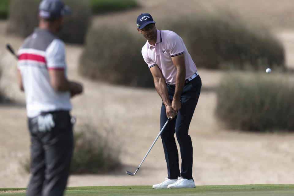 Alvaro Quiros chips onto the green on the 11th hole during round two of the Dubai Desert Classic golf tournament in Dubai, United Arab Emirates, Friday, Jan. 25, 2019. (AP Photo/Neville Hopwood)