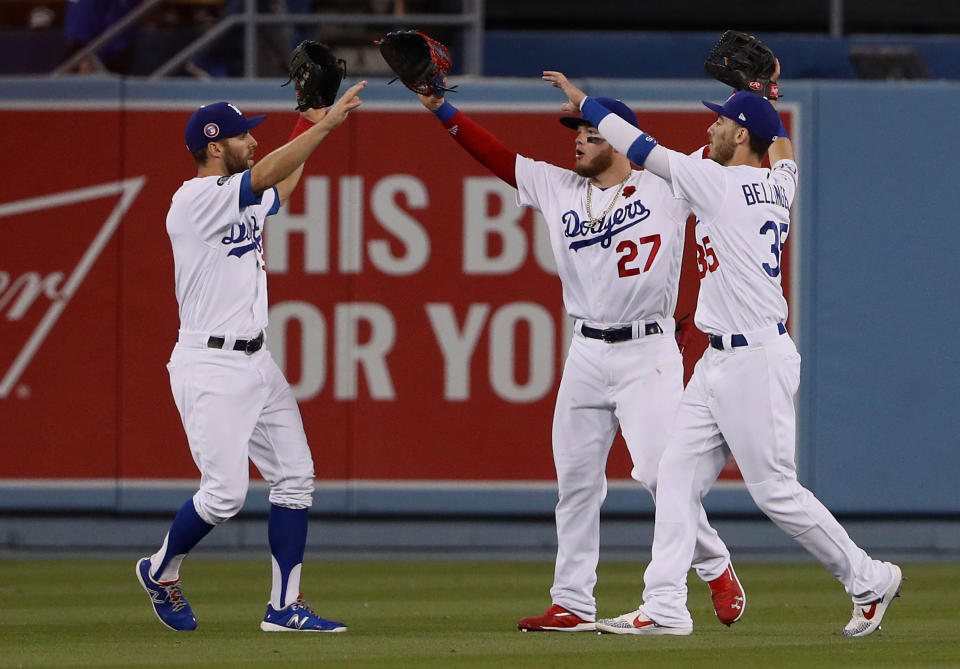 LOS ANGELES, CALIFORNIA - MAY 27: (L-R) Chris Taylor #3, Alex Verdugo #27 and Cody Bellinger #35 of the Los Angeles Dodgers celebrate in the outfield after defeating the New York Mets 9-5 in their MLB game at Dodger Stadium on May 27, 2019 in Los Angeles, California. (Photo by Victor Decolongon/Getty Images)