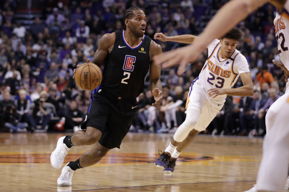 Los Angeles Clippers forward Kawhi Leonard (2) drives as Phoenix Suns forward Cameron Johnson (23) pursues during the first half of an NBA basketball game, Wednesday, Feb. 26, 2020, in Phoenix. (AP Photo/Matt York)