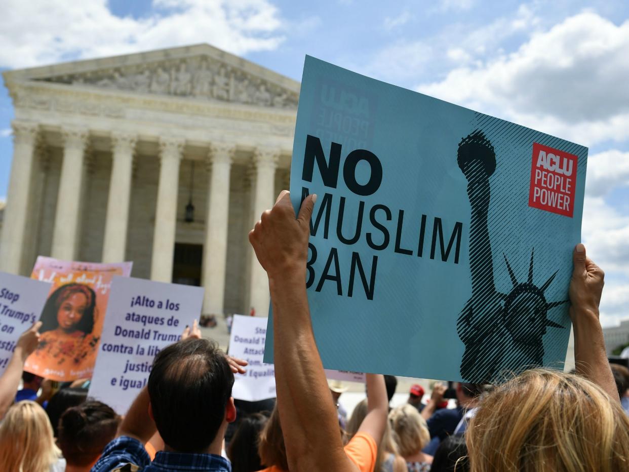 People protest the Muslim travel ban outside of the US Supreme Court in Washington, DC on 26 June 2018 just before the court upheld Donald Trump's travel ban: MANDEL NGAN/AFP/Getty Images