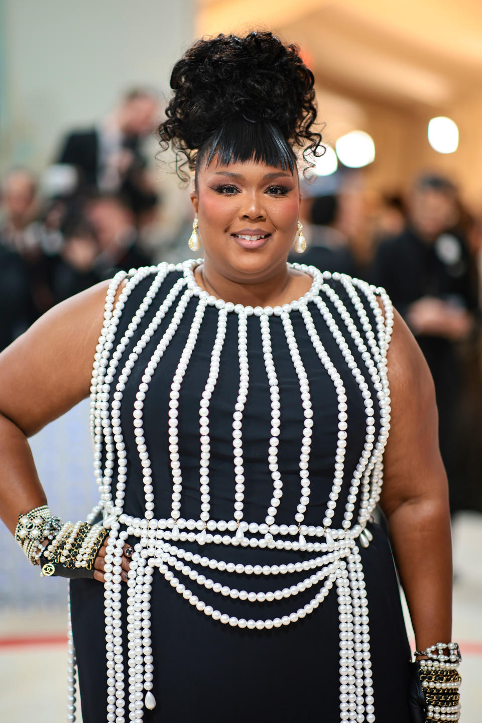 Lizzo in a sleeveless, beaded dress