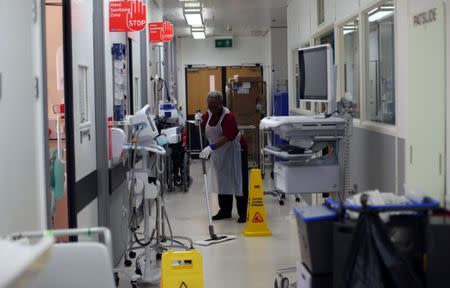 A hospital worker cleans the floor of Ward 8 in Milton Keynes University Hospital in Milton Keynes, central England, Britain, June 6, 2018. REUTERS/Hannah McKay