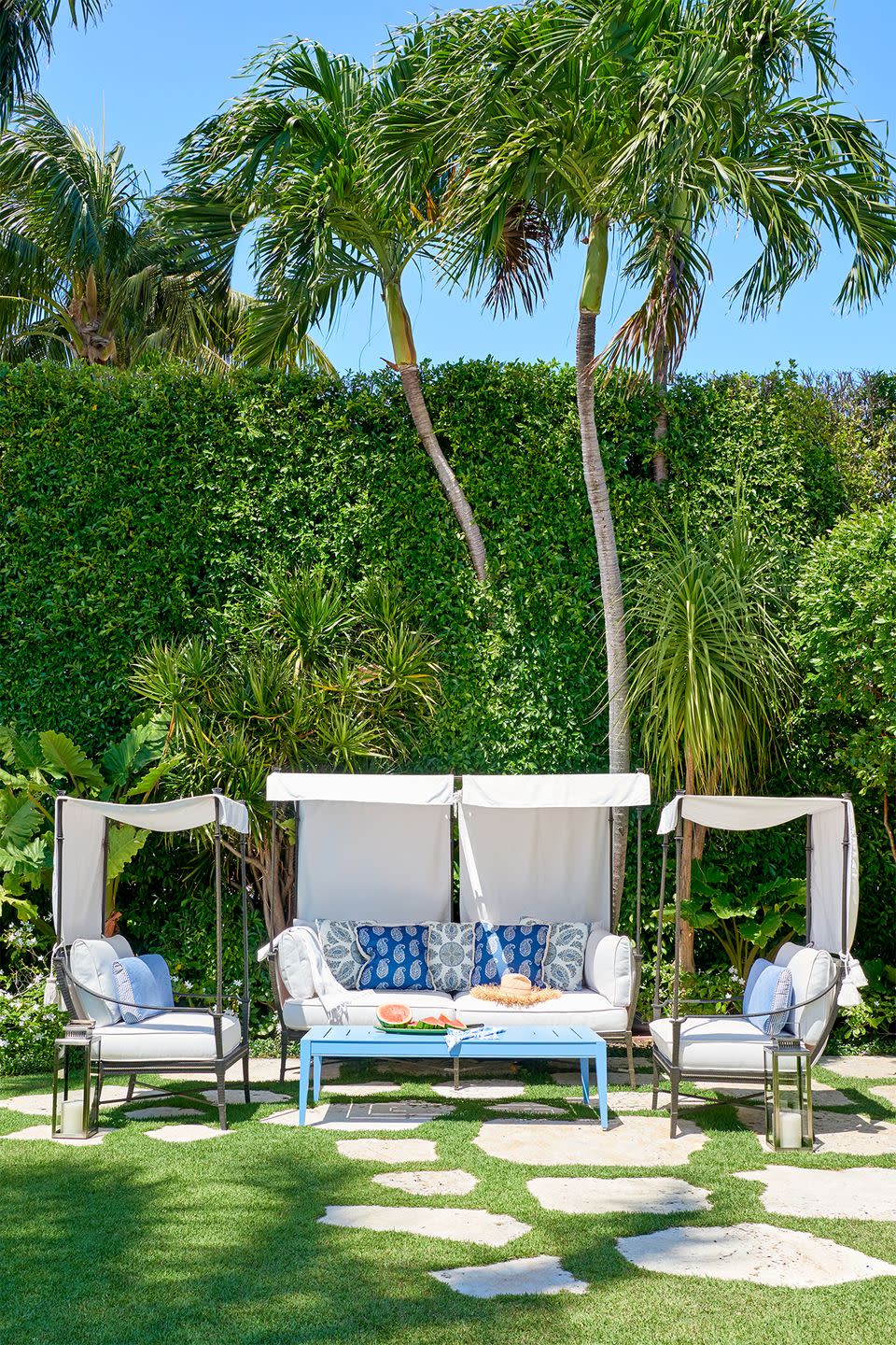 <p>Turn your backyard into a tropical oasis (well, kind of) by sticking patio furniture straight on the grass. Fill out the space with plush pillows, patterned blankets and battery-operated lanterns.</p>