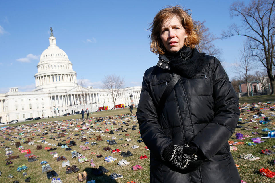 <p>Lori Haas, whose daughter was shot twice at Virginia Tech, stands among 7,000 empty pairs of shoes for every child killed by guns in the US since Sandy Hook at the U.S. Capitol Building on Tuesday, March 13, 2018 in Washington. (Photo: Paul Morigi/AP Images for AVAAZ) </p>