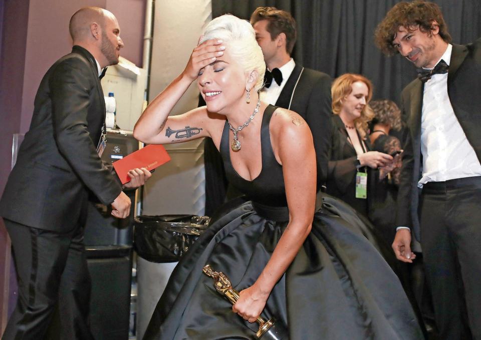 An emotional Lady Gaga clutches her Oscar for best original song (for "Shallow") backstage in 2019.
