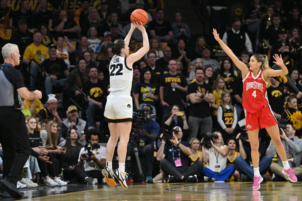 Mar 3, 2024; Iowa City, Iowa, USA; Iowa Hawkeyes guard Caitlin Clark (22) shoots a three point basket as Ohio State Buckeyes guard Jacy Sheldon (4) defends during the first quarter at Carver-Hawkeye Arena. Mandatory Credit: Jeffrey Becker-USA TODAY Sports