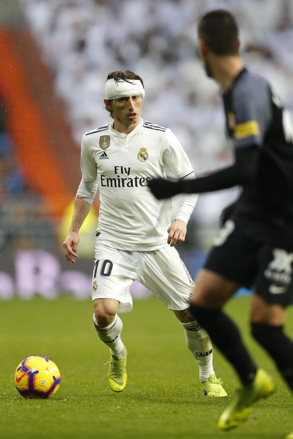 Real Madrid's Luka Modric, left, controls the ball during La Liga soccer match between Real Madrid and Sevilla at the Bernabeu stadium in Madrid, Spain, Saturday, Jan. 19, 2019. (AP Photo/Andrea Comas)