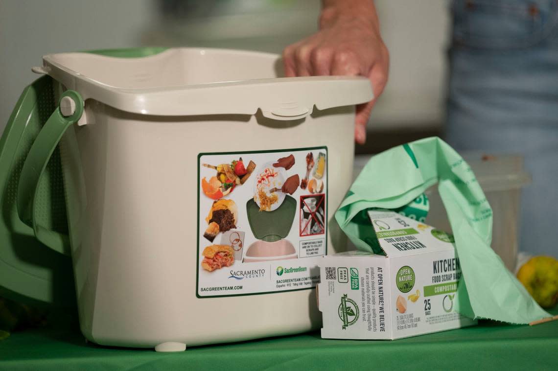 Jennifer Claiborne, program manager with Sacramento County Waste Management and Recycling, holds a container on Thursday that is available to customers as she demonstrates how to separate food scraps for the new curbside organic service that starts in July.