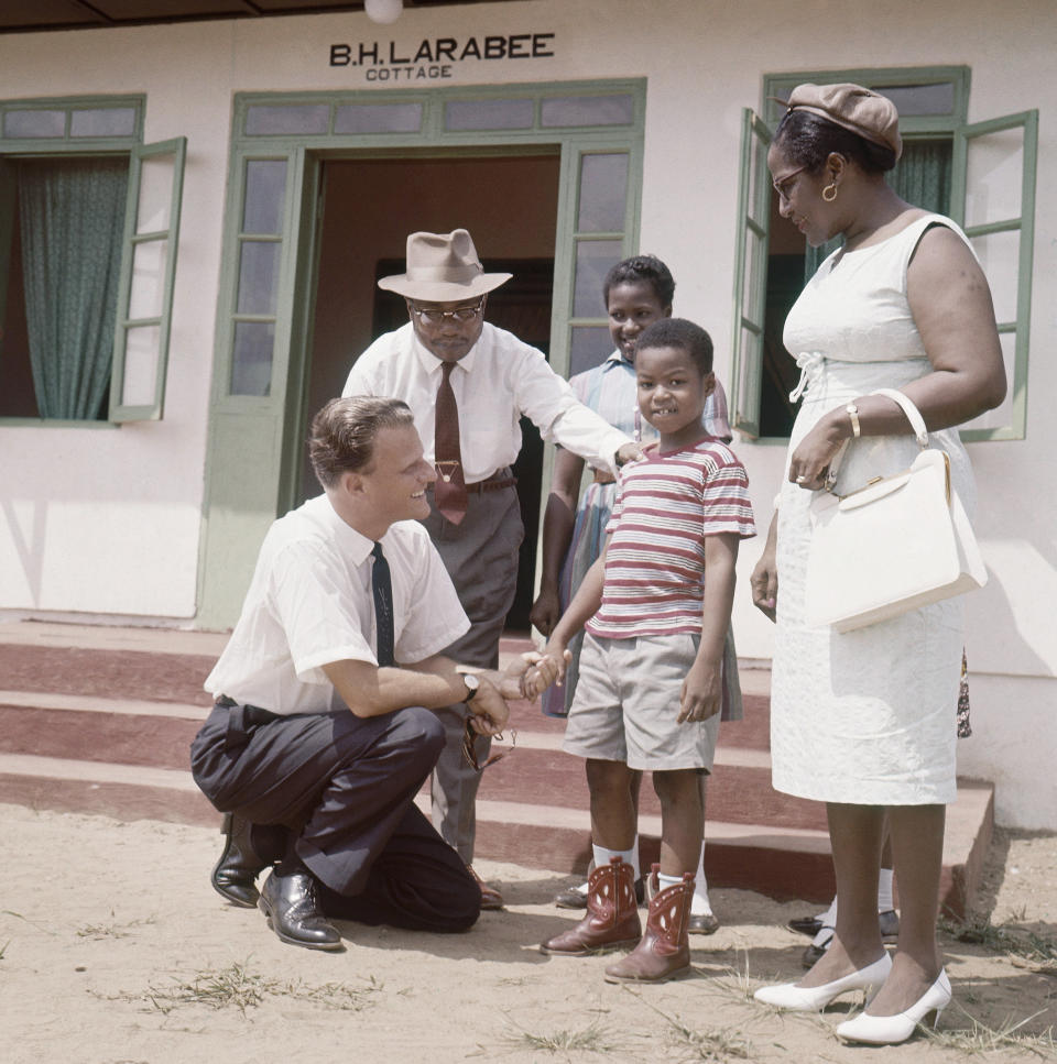 <p>Billy Graham meets children at Virginia Village, 20 miles from Monrovia, Liberia, in 1960. (Photo: AP) </p>