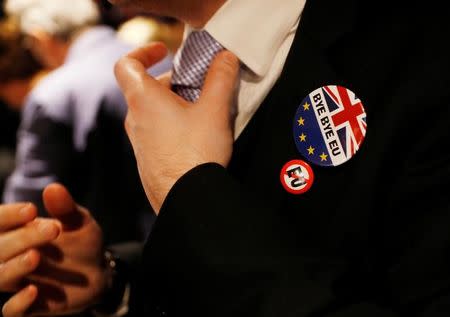 FILE PHOTO: A man adjusts his tie at a Pro-Brexit event to celebrate the invoking of Article 50 after Britain's Prime Minister Theresa May triggered the process by which the United Kingdom will leave the European Union, in London, Britain March 29, 2017. REUTERS/Peter Nicholls