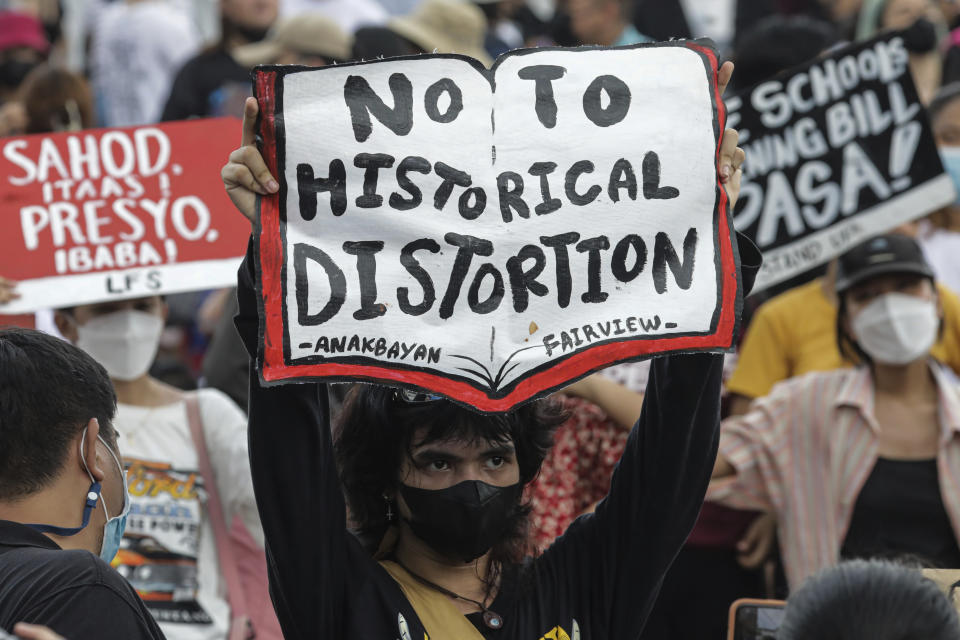 A protester raises a placard during a rally against the State of the Nation address in Quezon City, Philippines Monday, July 25, 2022. Philippine President Ferdinand Marcos Jr. will deliver his first State of the Nation address Monday with momentum from his landslide election victory, but he's hamstrung by history as an ousted dictator’s son and daunting economic headwinds. (AP Photo/Gerard Carreon)