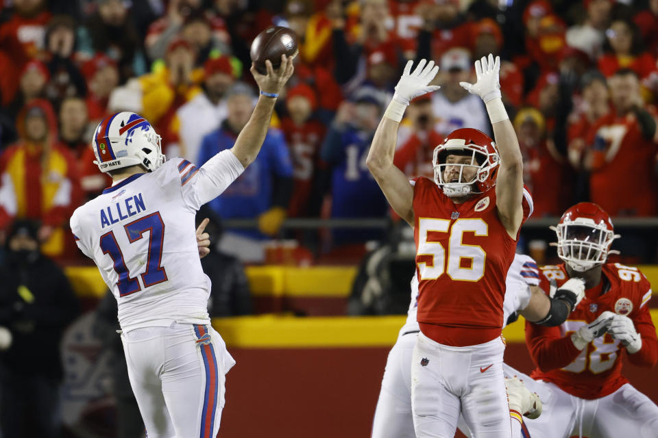 Buffalo Bills quarterback Josh Allen (17) throws a pass over Kansas City Chiefs outside linebacker Ben Niemann (56) during the first half of an NFL divisional round playoff football game, Sunday, Jan. 23, 2022, in Kansas City, Mo. (AP Photo/Colin E. Braley)