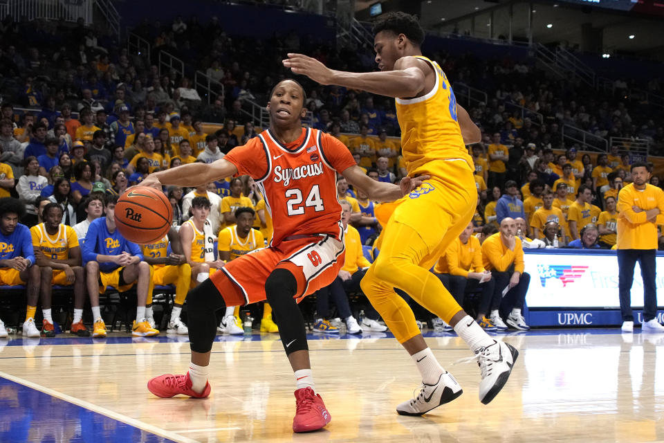 Syracuse's Quadir Copeland (24) drives the baseline with Pittsburgh's William Jeffress defending during the first half of an NCAA college basketball game in Pittsburgh on Tuesday, Jan. 16, 2024. (AP Photo/Gene J. Puskar)