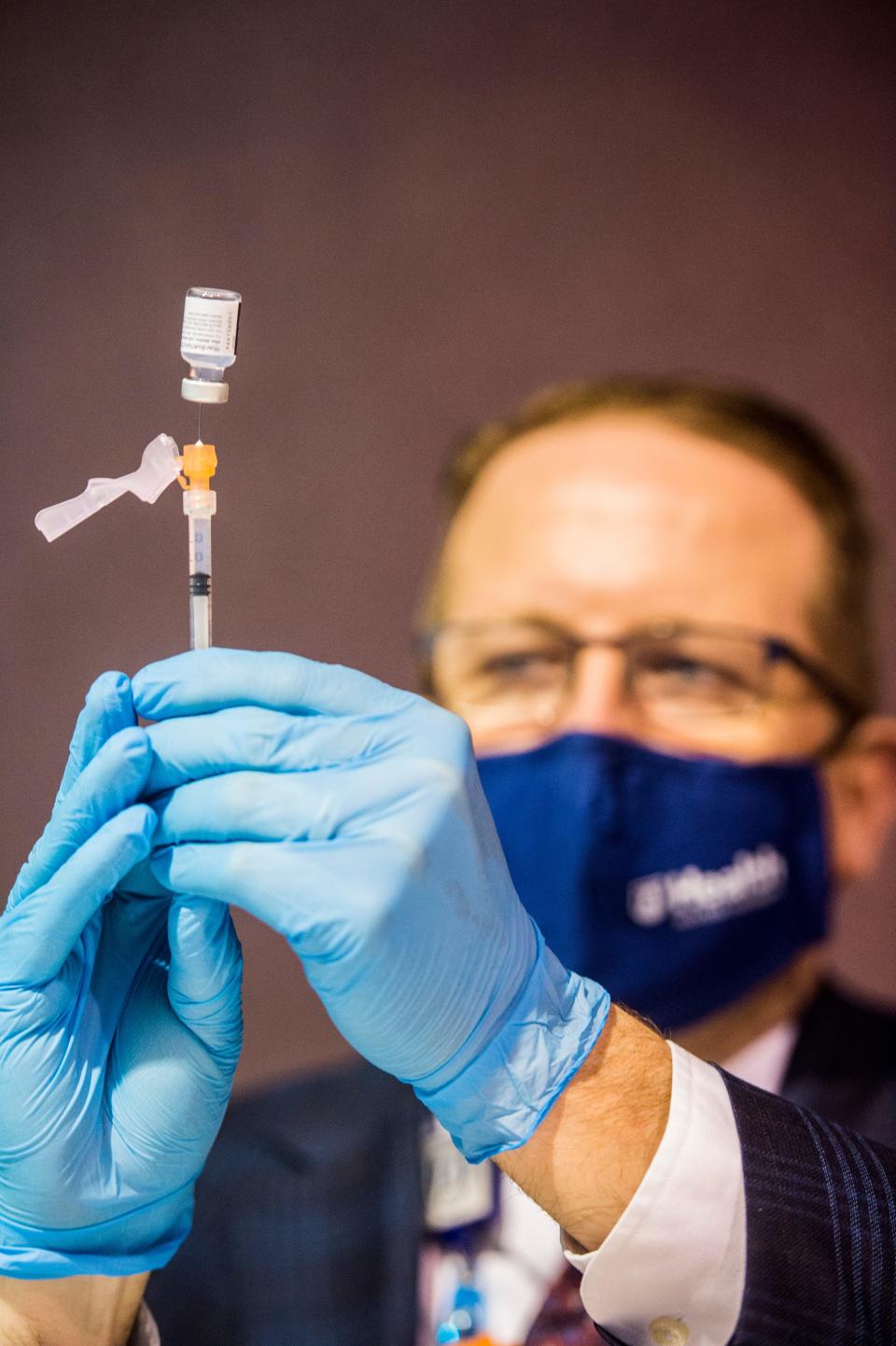 Augusta University Health Pharmacy Manager Todd Davis fills a syringe with the Pfizer COVID vaccine. AU's clinic on Washington Road has been incredibly popular, but was closed in January to focus efforts on their testing clinic in the downtown Augusta medical district.
