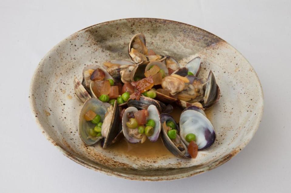 Clams cooked with guanciale, fresh peas and fino, at Flora restaurant, London.