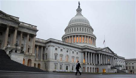 A man walks past the Capitol Building in Washington December 17, 2012. REUTERS/Joshua Roberts