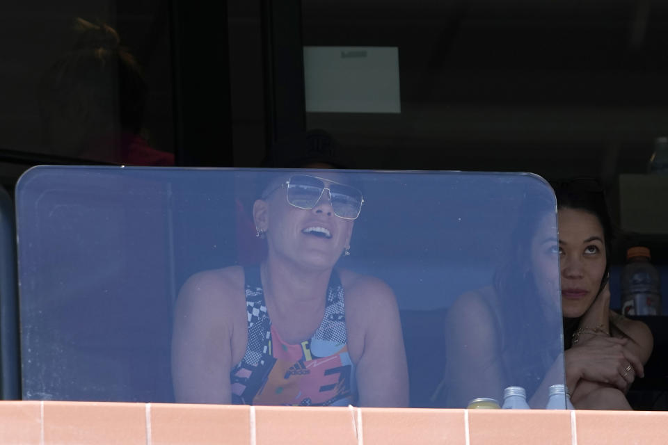 Pink, left, watches a semifinal match between Daniil Medvedev, of Russia, and Frances Tiafoe, of the United States, at the BNP Paribas Open tennis tournament Saturday, March 18, 2023, in Indian Wells, Calif. (AP Photo/Mark J. Terrill)