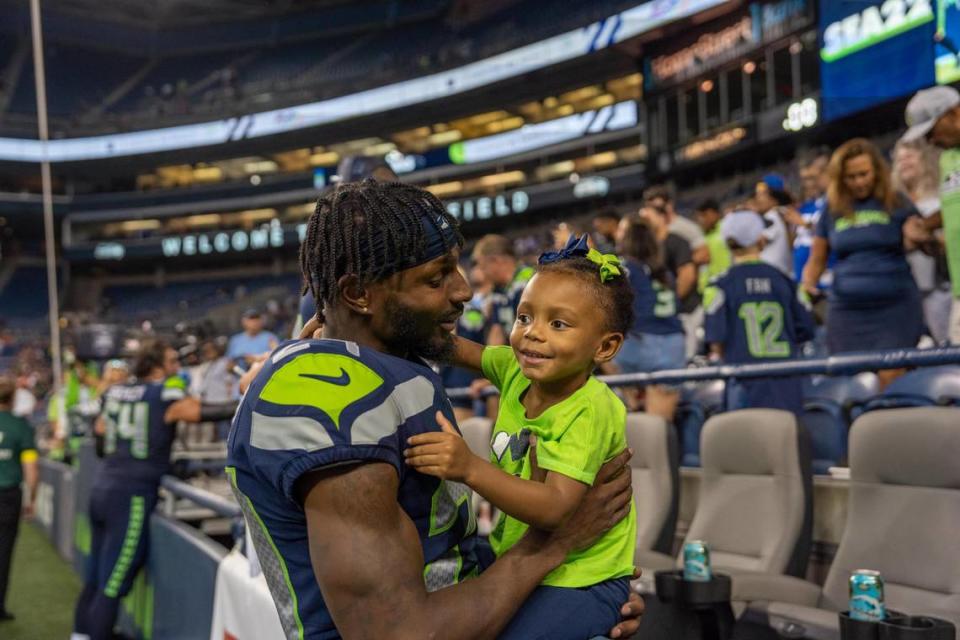 Seattle Seahawks cornerback Justin Coleman with his three year-old daughter Lotus Sage after their first home preseason game against the Chicago Bears in Lumen Field on Aug. 18, 2022.