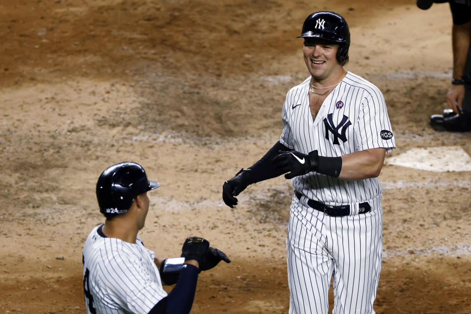 New York Yankees' Luke Voit celebrates his three-run home run with Gary Sanchez during the fifth inning of the second baseball game of the team's doubleheader against the Baltimore Orioles, Friday, Sept. 11, 2020, in New York. (AP Photo/Adam Hunger)