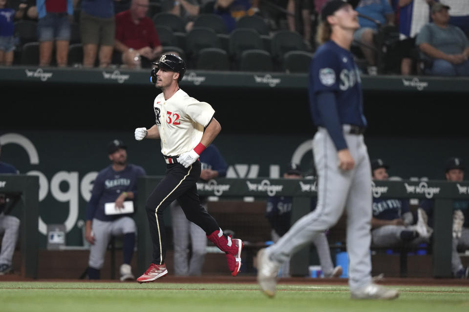 Texas Rangers' Evan Carter heads for home with a three-run home run off Seattle Mariners starting pitcher Bryce Miller, right, during the second inning of a baseball game in Arlington, Texas, Friday, Sept. 22, 2023. (AP Photo/LM Otero)