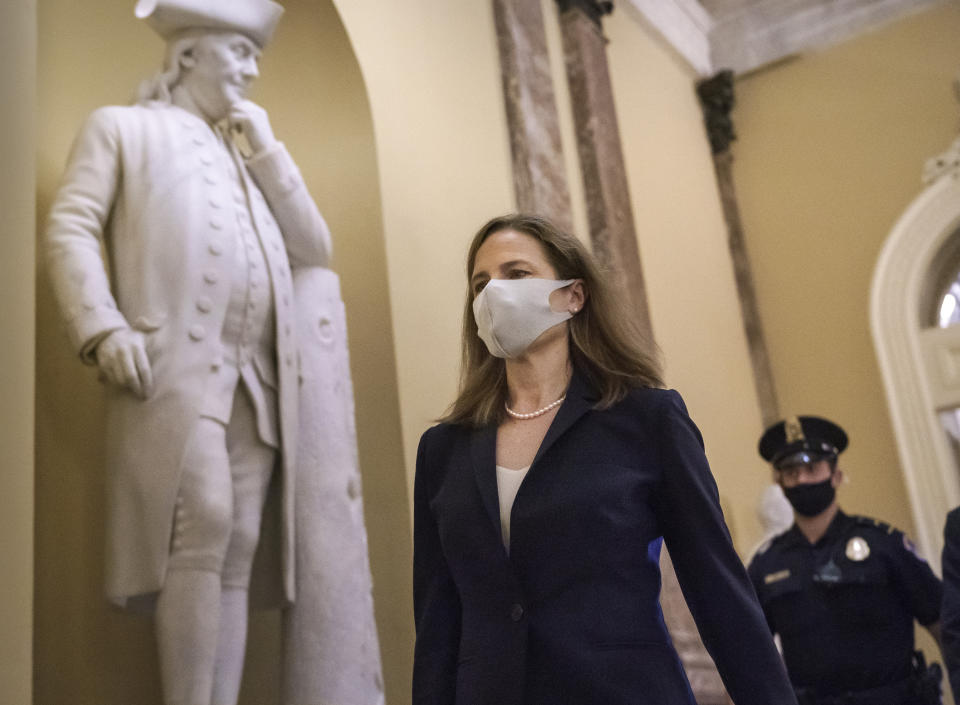 Judge Amy Coney Barrett, President Donald Trump's nominee for the Supreme Court, arrives for closed meetings with senators, at the Capitol in Washington, Wednesday, Oct. 21, 2020. (AP Photo/J. Scott Applewhite)