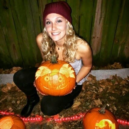 a woman holding a Hey Arnold pumpkin