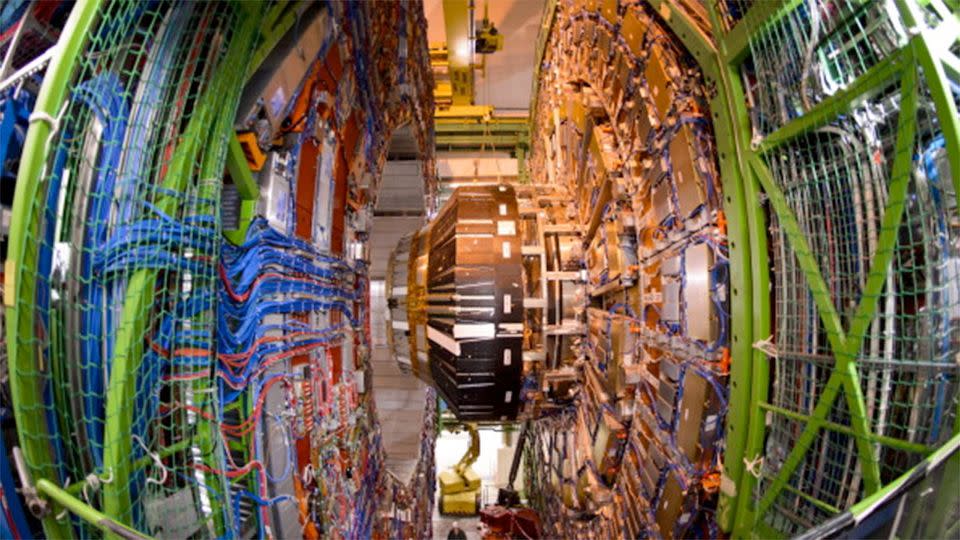 Deep below the border between Switzerland and France, the tunnel stretches out of sight, decked with silver installations fit for a starship. A year ago, this collider made one of the greatest discoveries in the history of science. AFP PHOTO / FABRICE COFFRINI