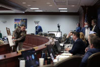 South Dakota Highway Patrol Sgt. Kevin Kinney, left, points to a diagram of the 2020 crash in which South Dakota Attorney General Jason Ravnsborg struck and killed a man walking near a rural highway, during a House impeachment investigative committee meeting in Pierre, S.D., on Tuesday, Jan. 18, 2022. Lawmakers are weighing whether Ravnsborg should face impeachment charges. (AP Photo/Stephen Groves)