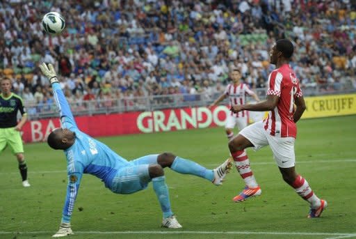 PSV Eindhoven's Georginio Wijnaldum (R) scores the 4-2 goal against Ajax Amsterdam during the Johan Cruyff Shield, a football trophy named after legendary Dutch football player Johan Cruyff, also often referred to as the Dutch Super Cup, on August 5, in Amsterdam. PSV won 4-2