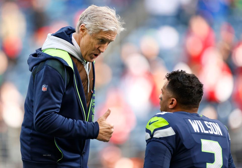 SEATTLE, WASHINGTON - DECEMBER 05: Head coach Pete Carroll of the Seattle Seahawks talks with Russell Wilson #3 during pregame warm-ups before the game against the San Francisco 49ers at Lumen Field on December 05, 2021 in Seattle, Washington. (Photo by Steph Chambers/Getty Images)