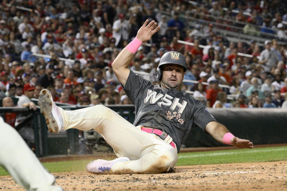 Washington Nationals' Jake Alu scores on a single by Blake Rutherford against the Philadelphia Phillies during the fourth inning of a baseball game Friday, Aug. 18, 2023, in Washington. (AP Photo/Nick Wass)