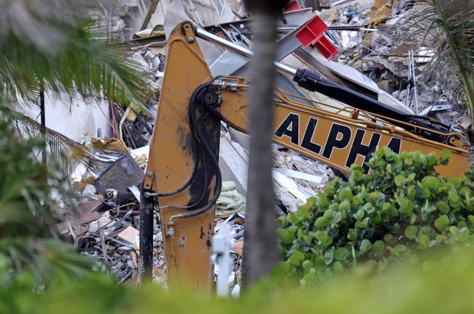 A crane sifts through rubble at the Champlain Towers South Condo in Surfside, Florida, Friday, June 25, 2021. The apartment building partially collapsed on Thursday, June 24.